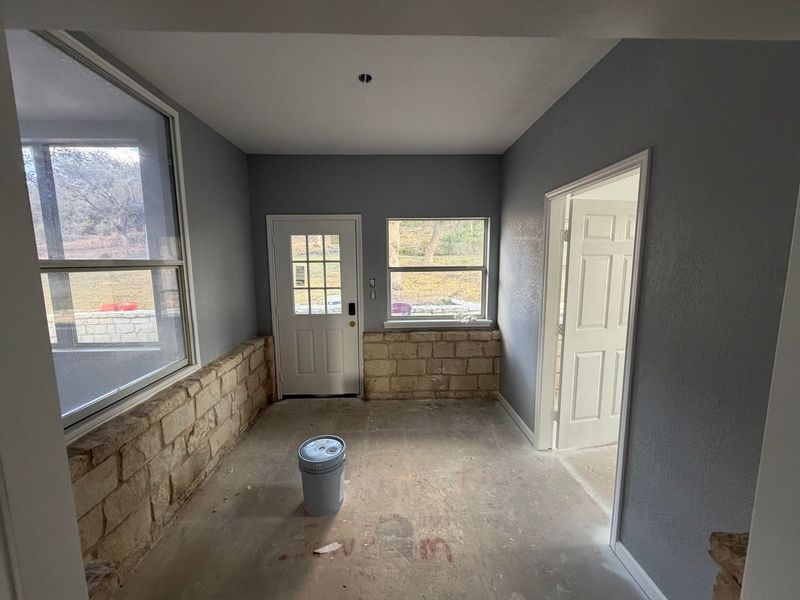 Finished room addition with stone wall and new windows and doors