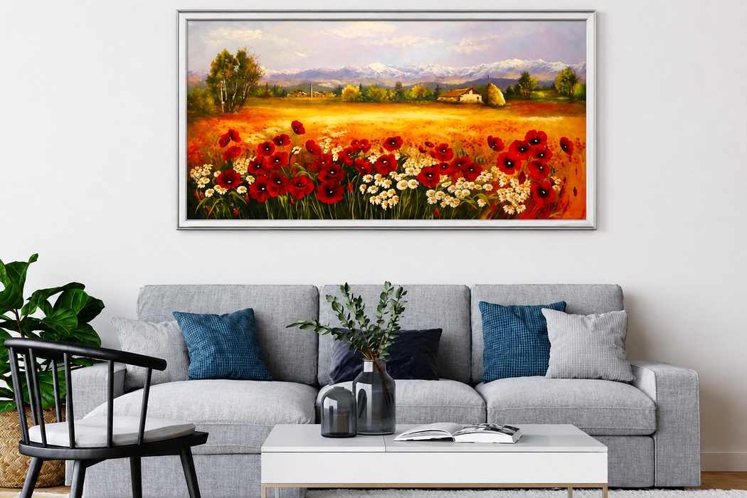 Soggiorno moderno con divano grigio, cuscini blu, tavolino bianco, piante e quadro con fiori rosso acceso.