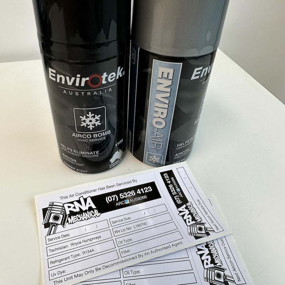 Two Spray Bottles of Envirotek Are Sitting on a Table Next to Each Other — RNA Mechanical In Nambour, QLD