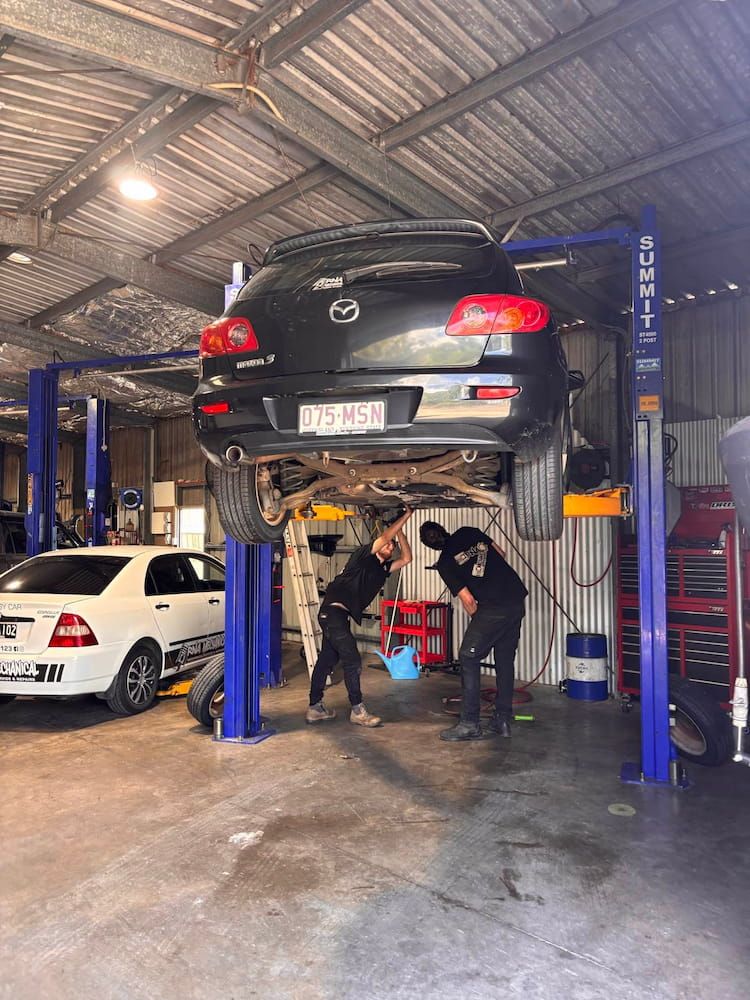 Two Men Are Working on a Car in a Garage — RNA Mechanical In Nambour, QLD