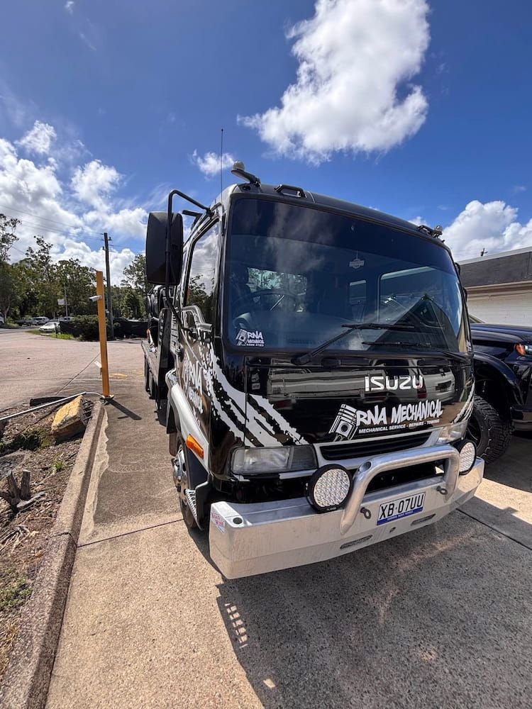 A Black and White Truck is Parked on the Side of the Road — RNA Mechanical In Coolum, QLD