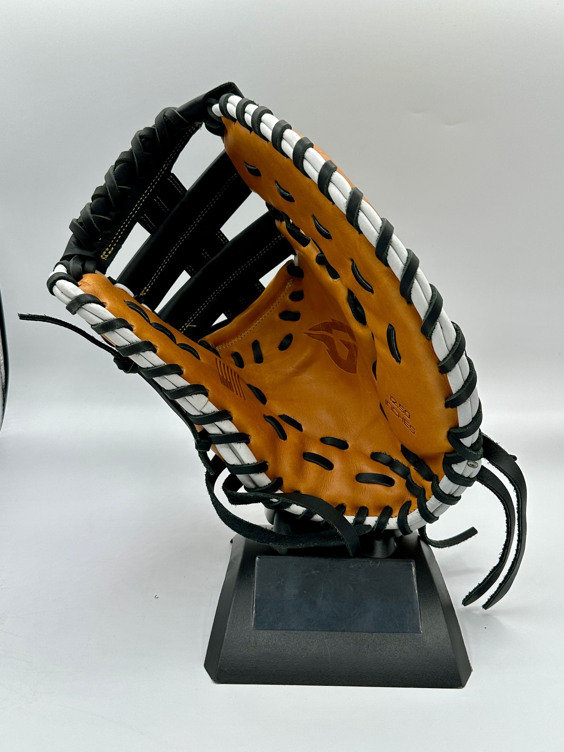 A baseball glove is sitting on a black stand