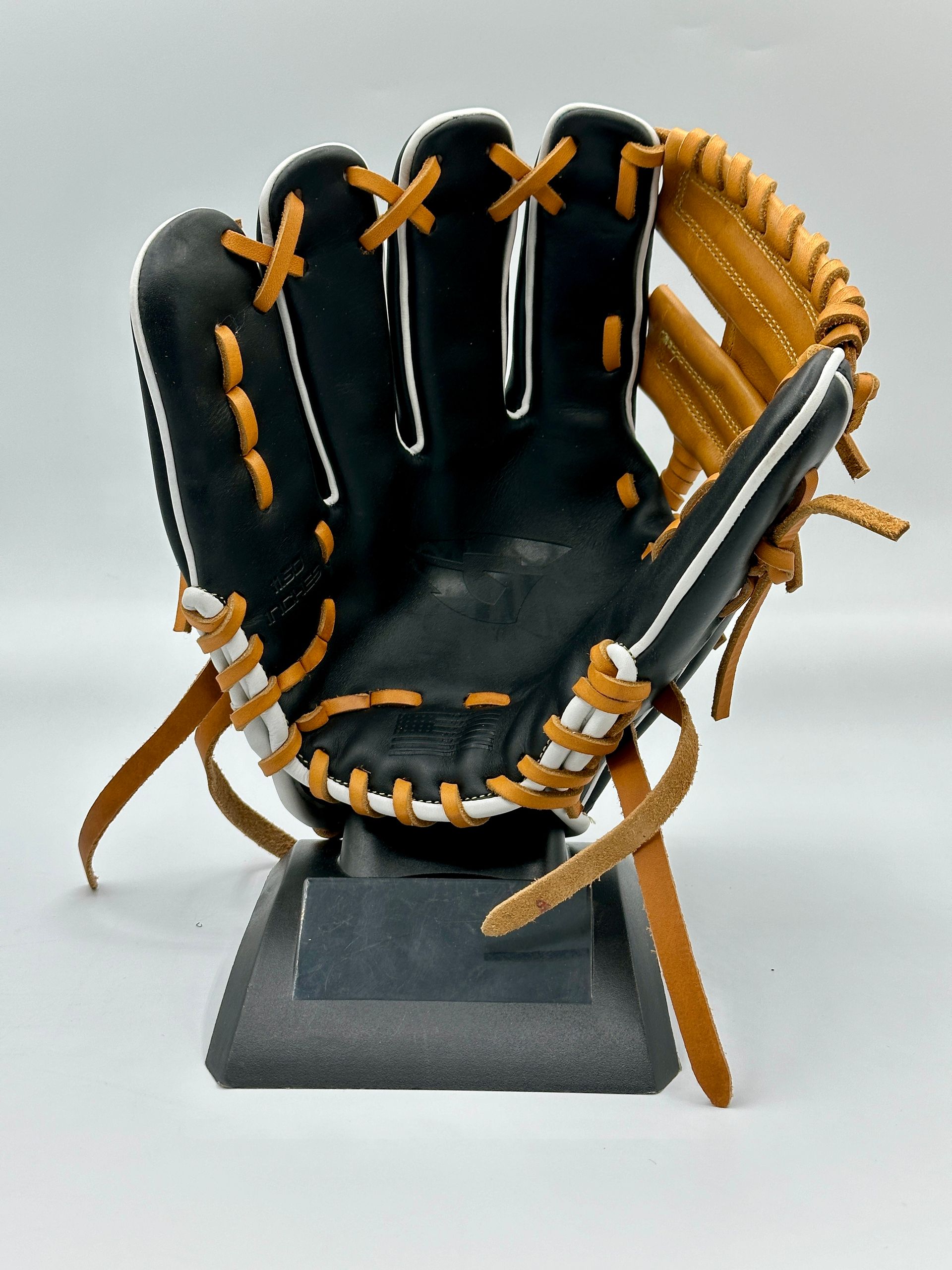 A baseball glove is sitting on top of a display stand.