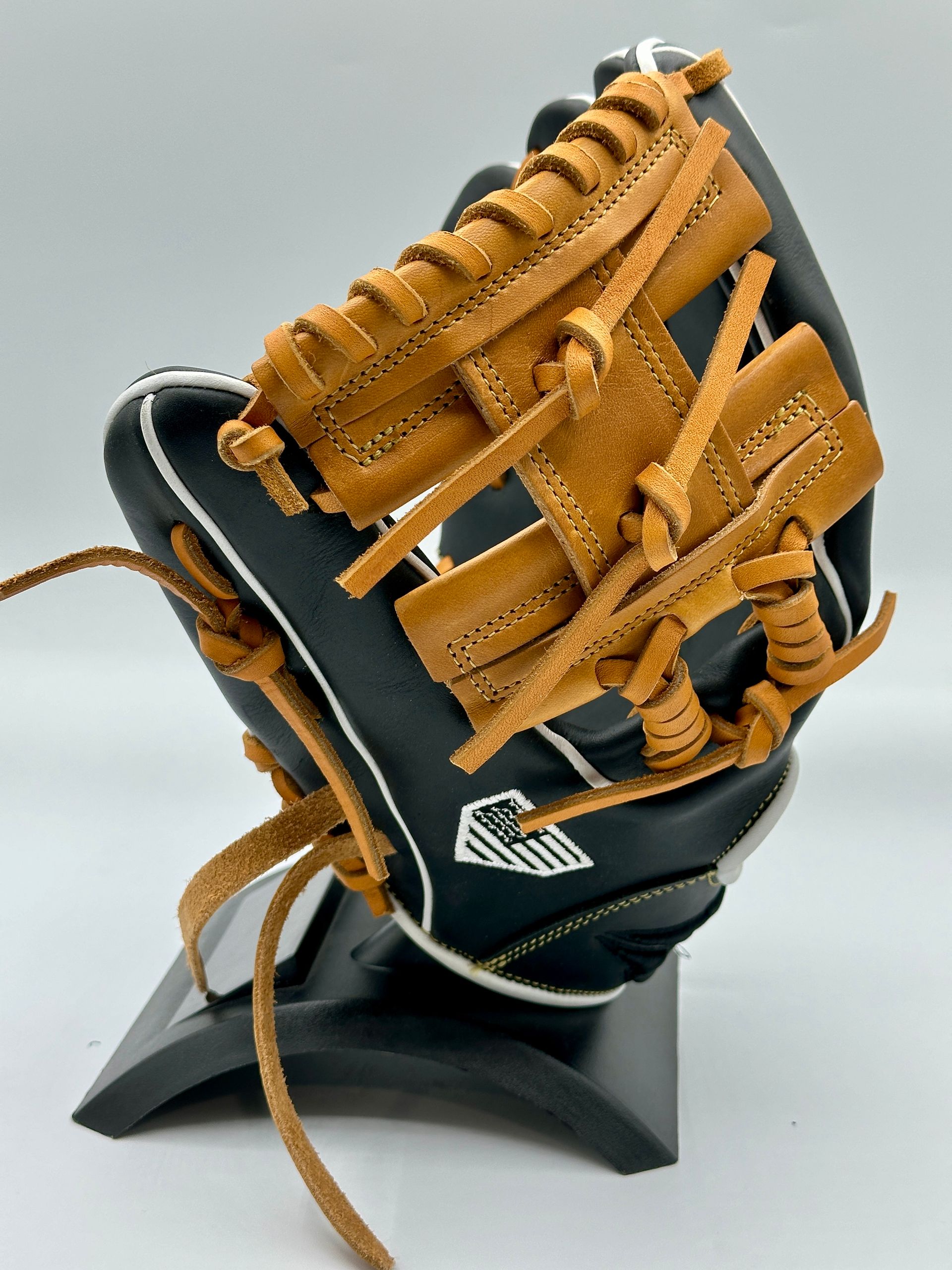 A baseball glove is sitting on a black stand