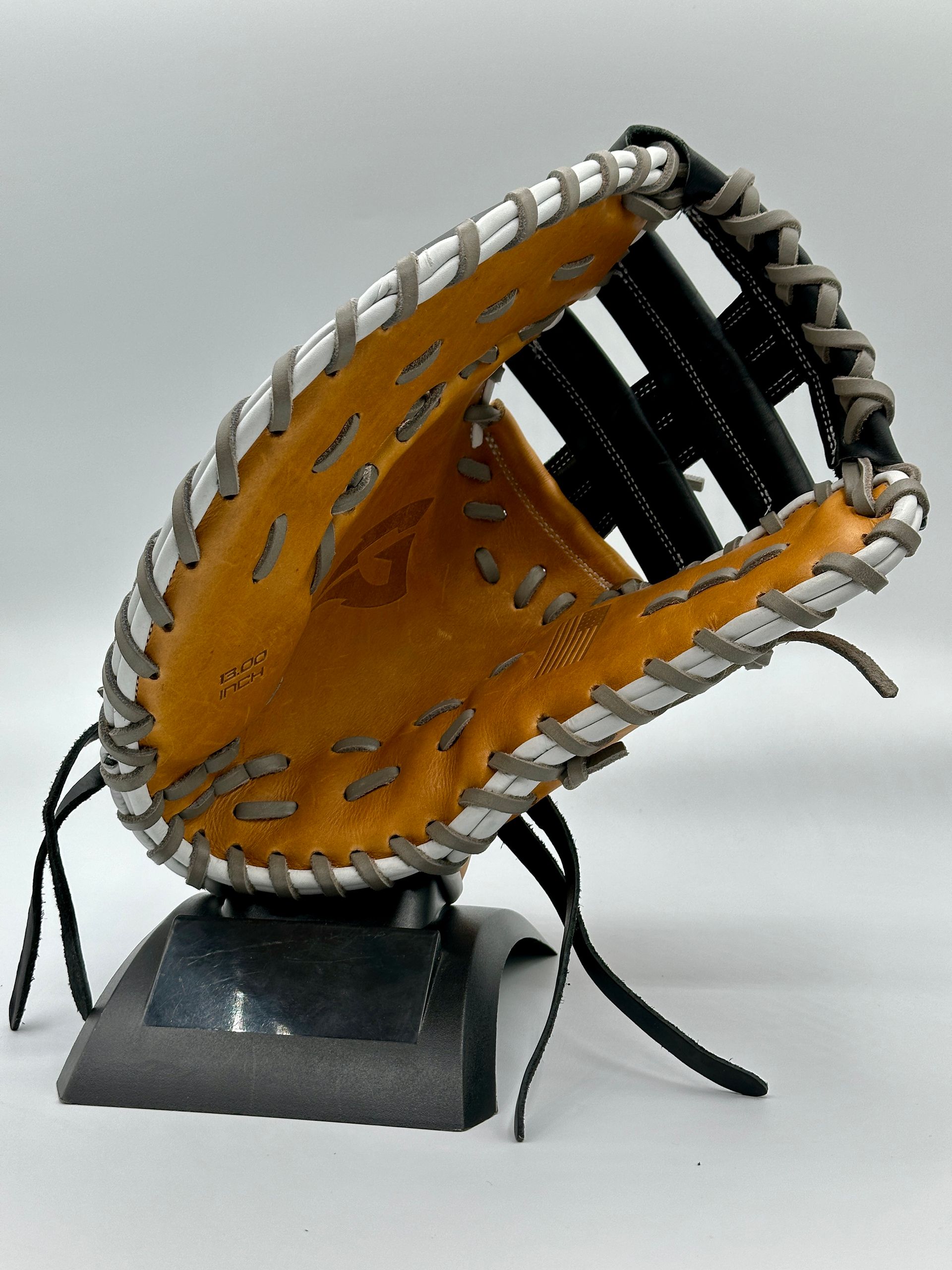 A baseball glove is sitting on top of a black base