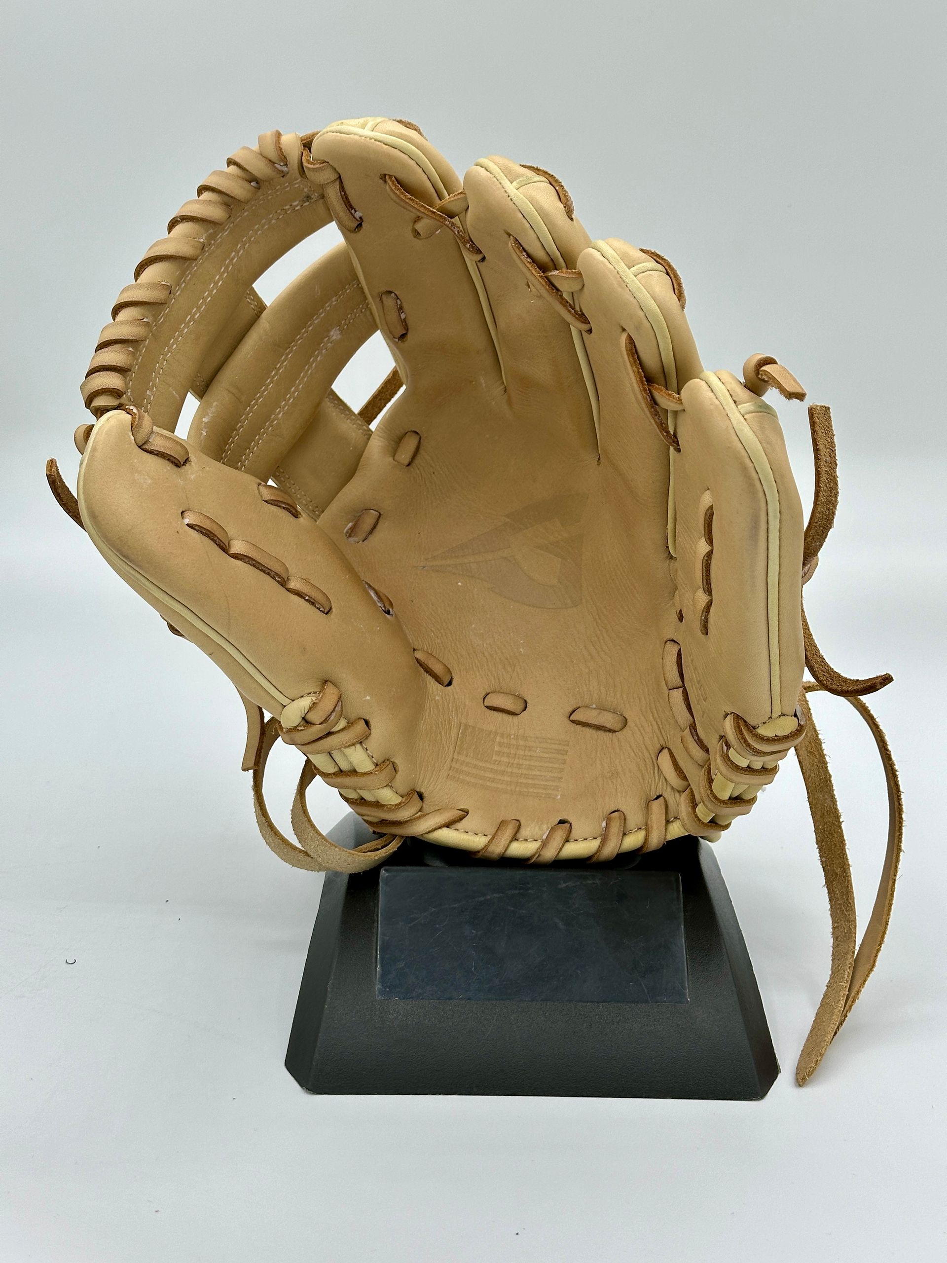 A baseball glove is sitting on a black base