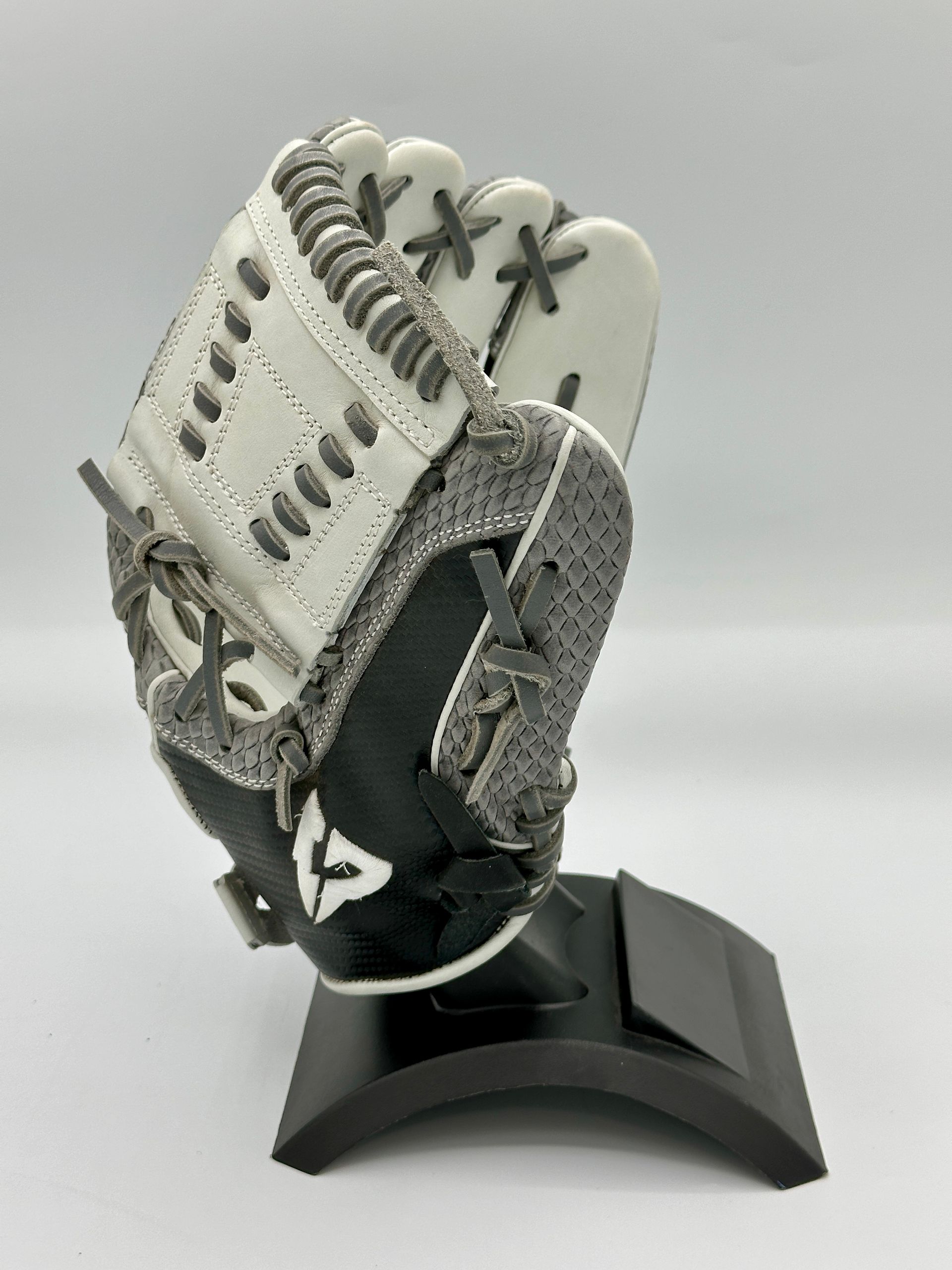 A baseball glove is sitting on a black stand