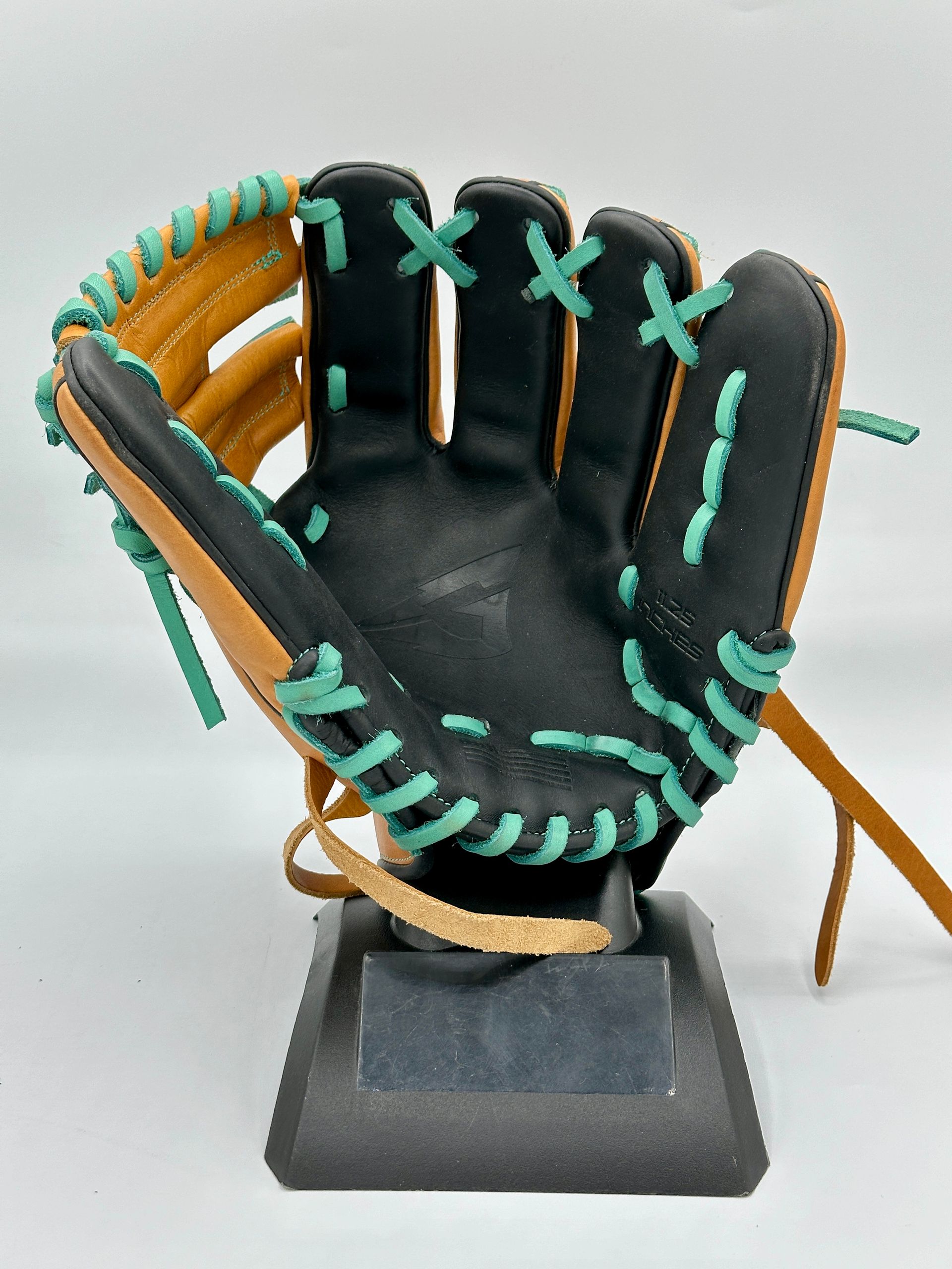 A baseball glove is sitting on a display stand