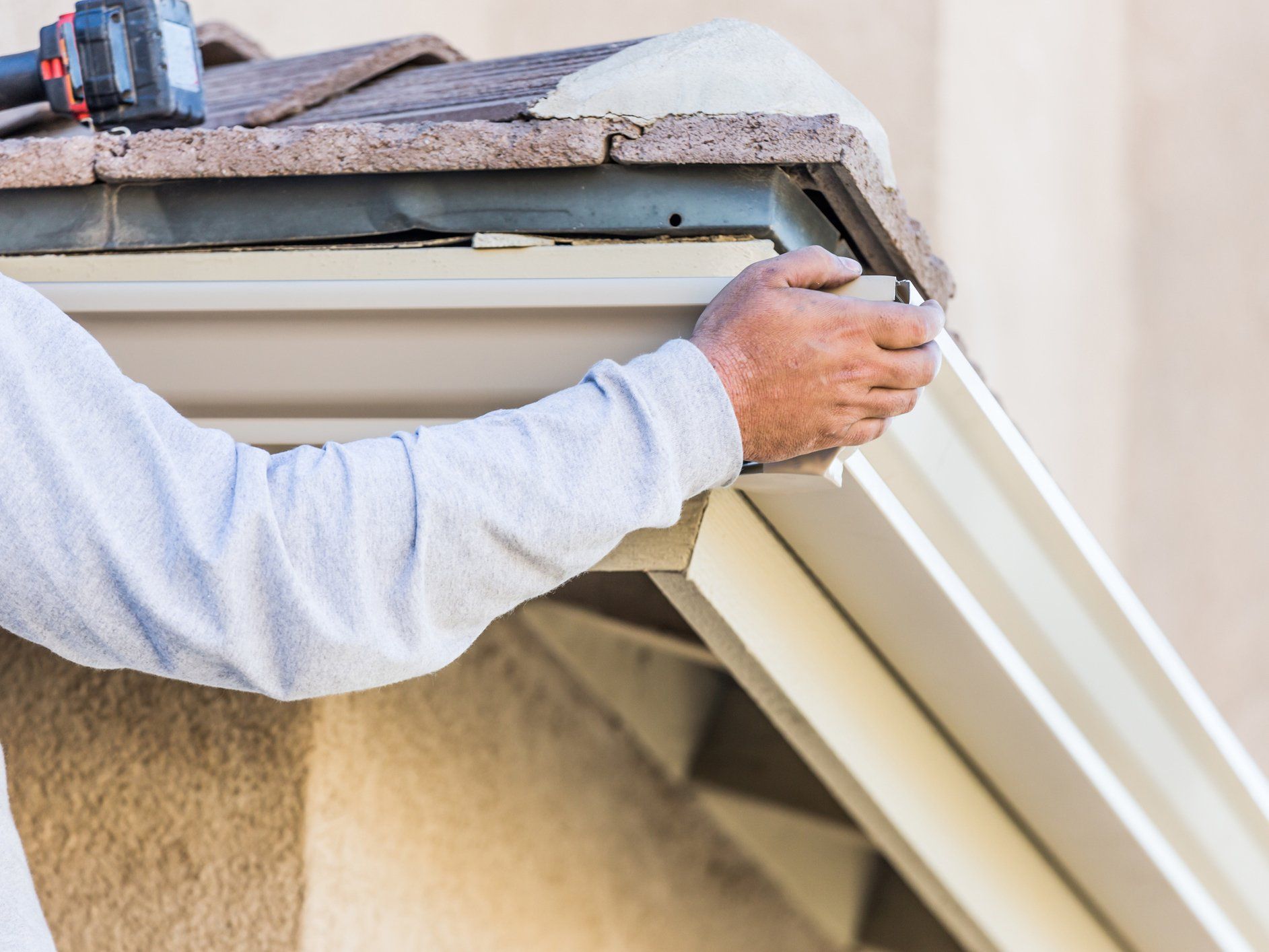 Worker Attaching Aluminum Rain Gutter - Stanardsville, VA - Nathaniel Greene Construction Co