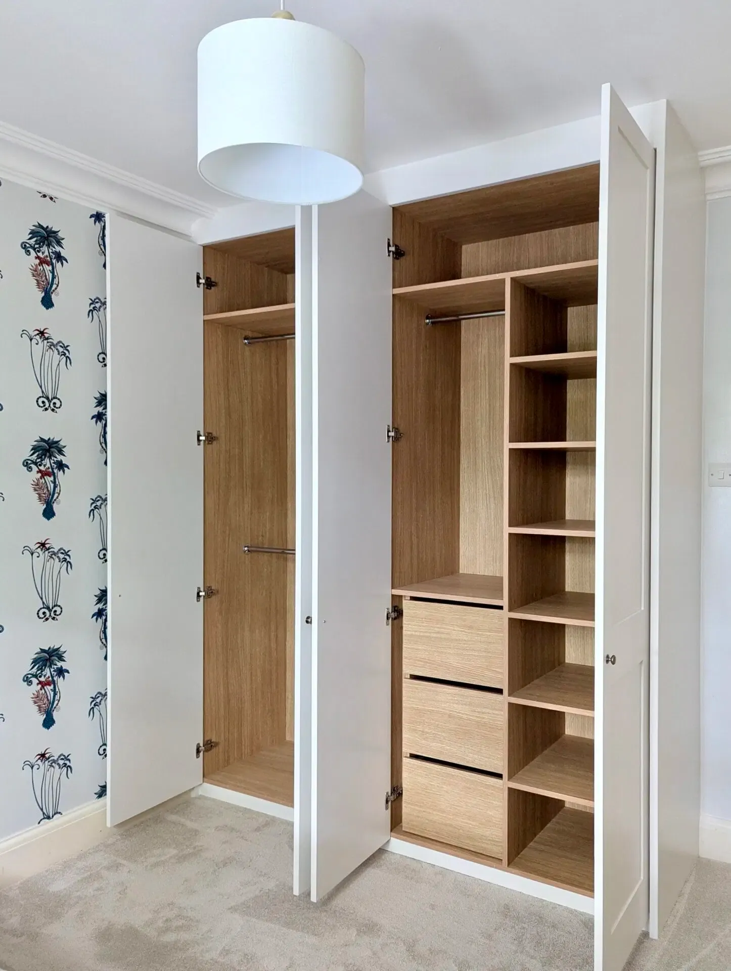 White open wardrobe with wooden interior and shelves.