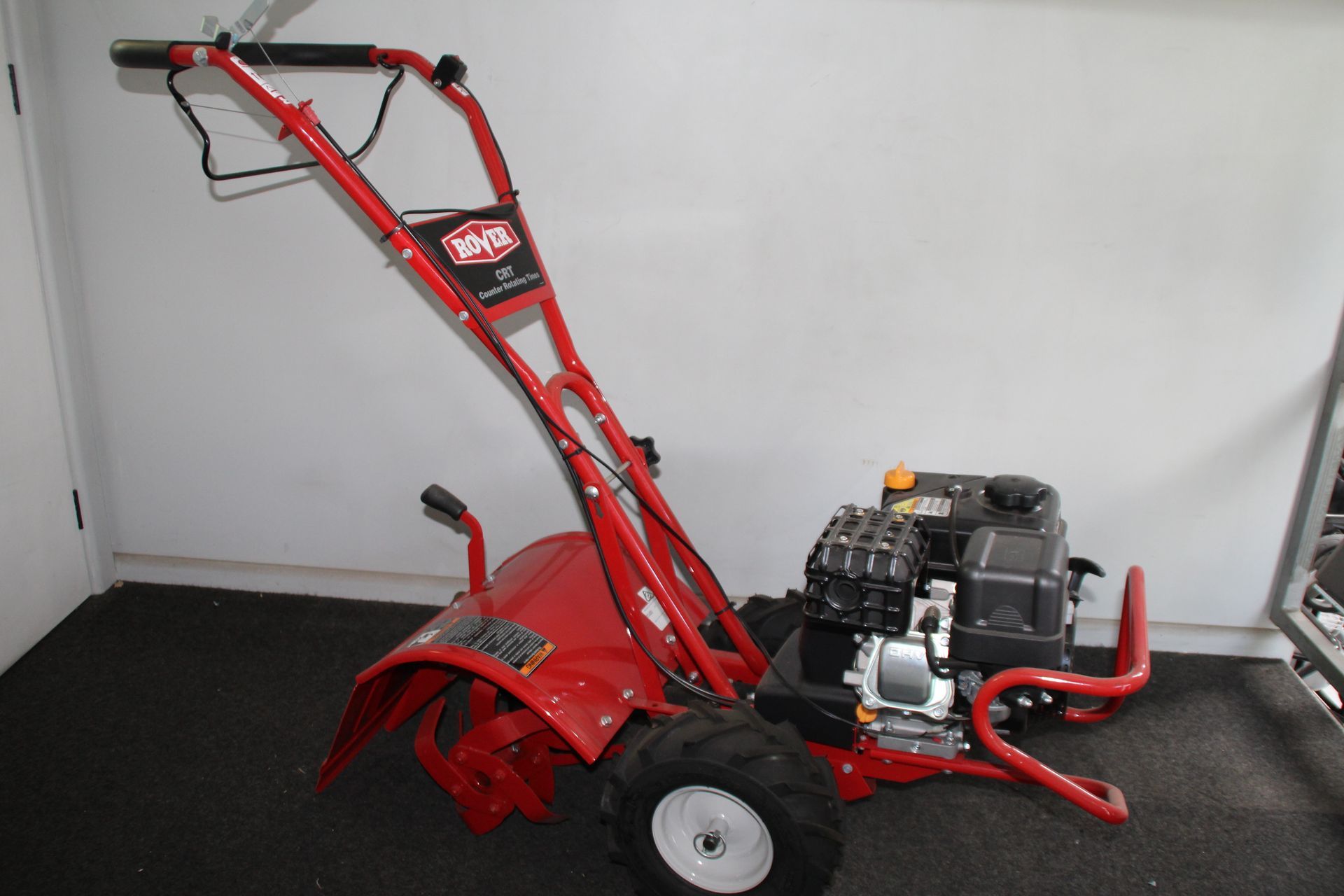A red rotary hoe.