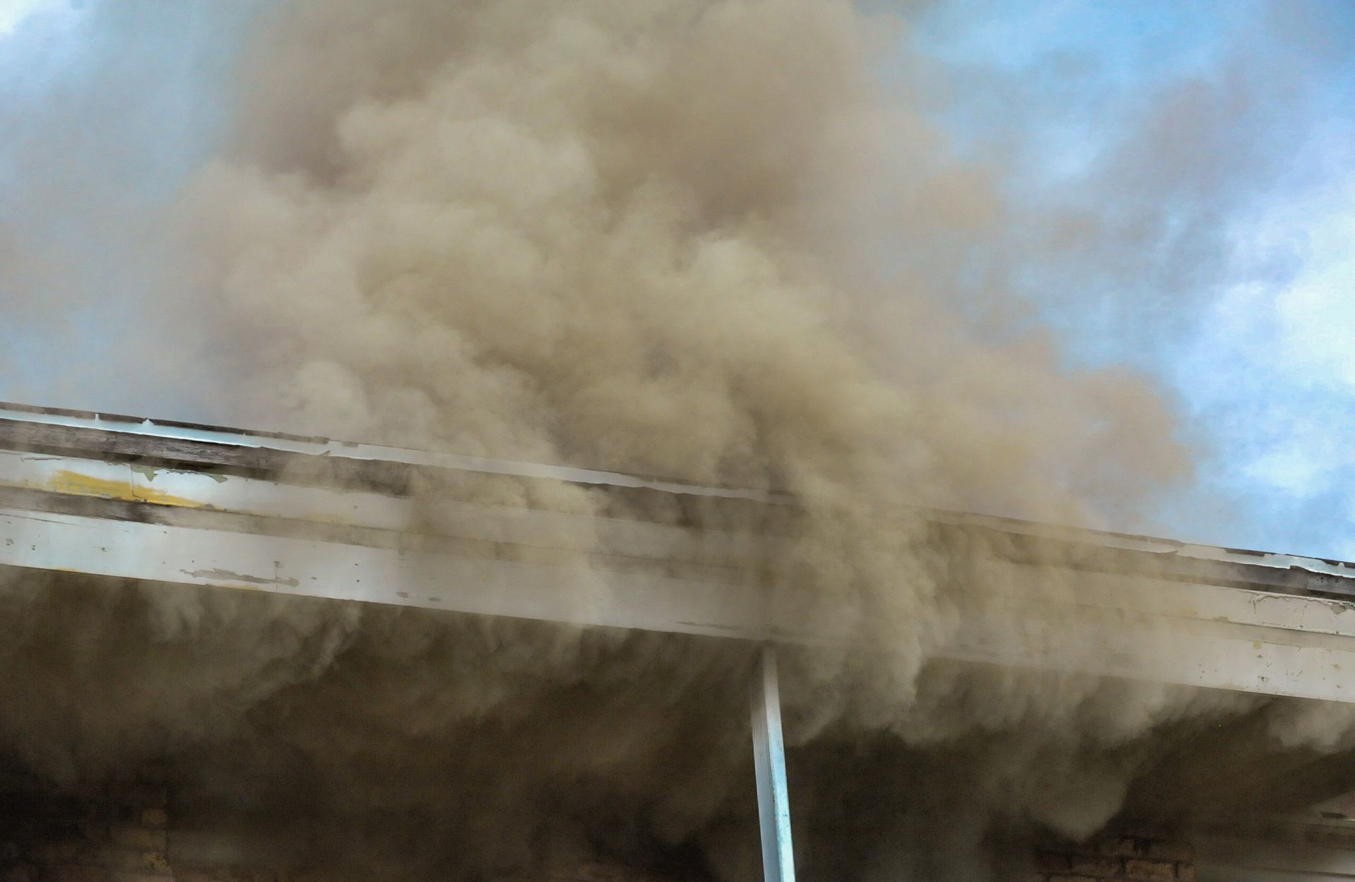 Smoke is coming out of the roof of a building