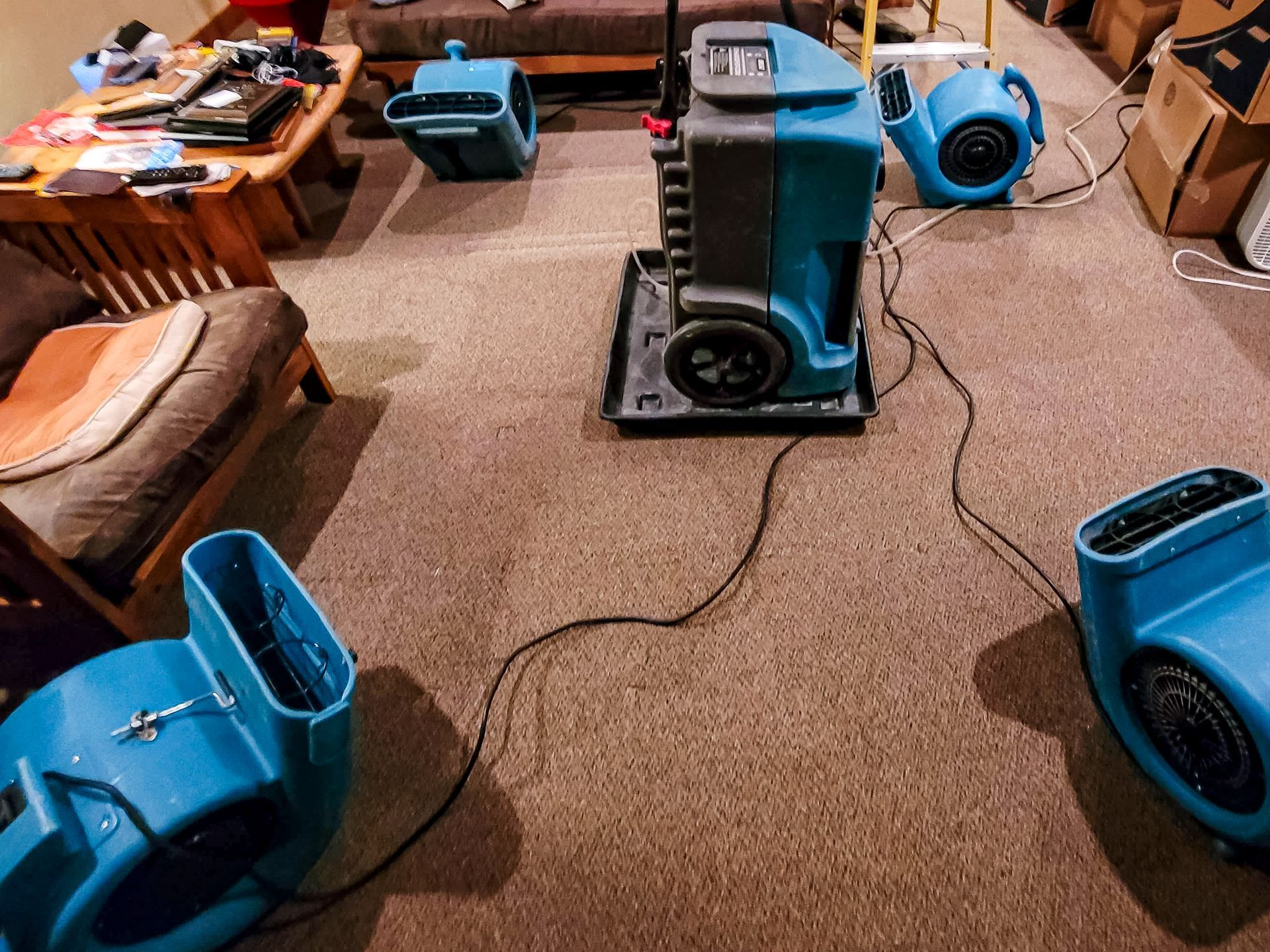A living room with a lot of blue appliances on the floor