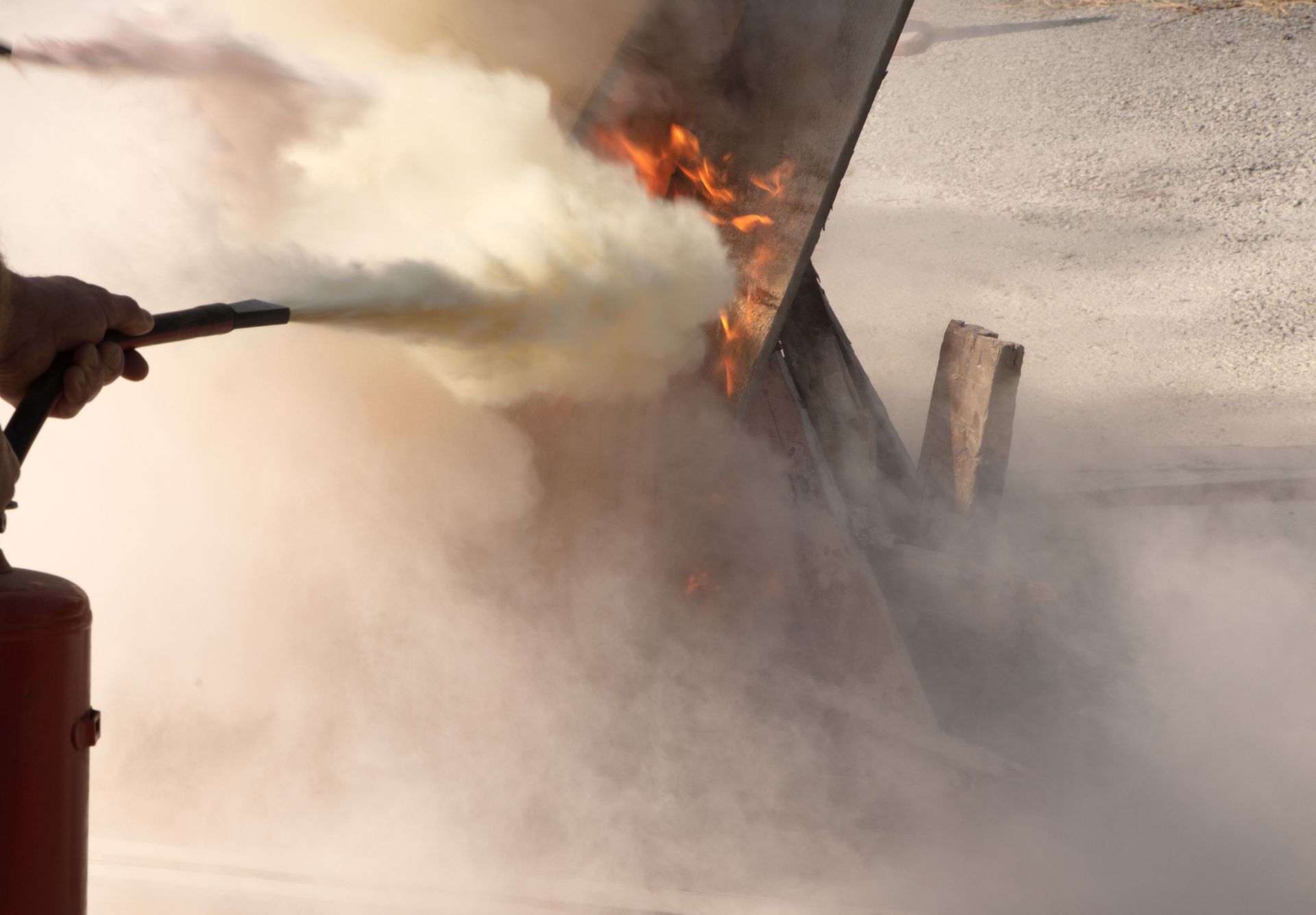 A person is using a fire extinguisher to put out a fire