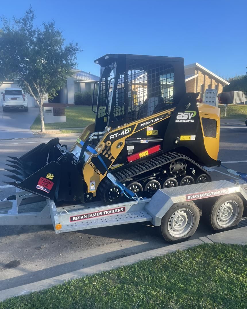 A Bulldozer Is on A Trailer Parked — R&J Cronin Equipment Hire in Bonnells Bay, NSW