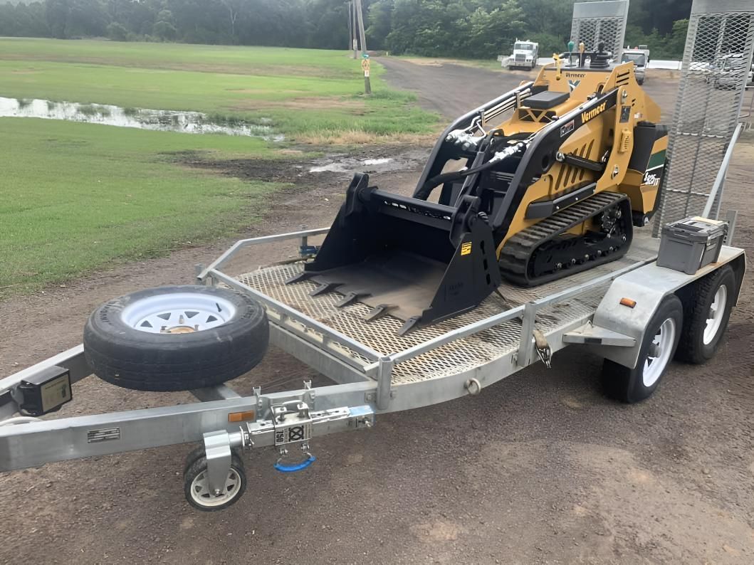 A Small Bulldozer Is Parked on A Trailer — R&J Cronin Equipment Hire in Bonnells Bay, NSW