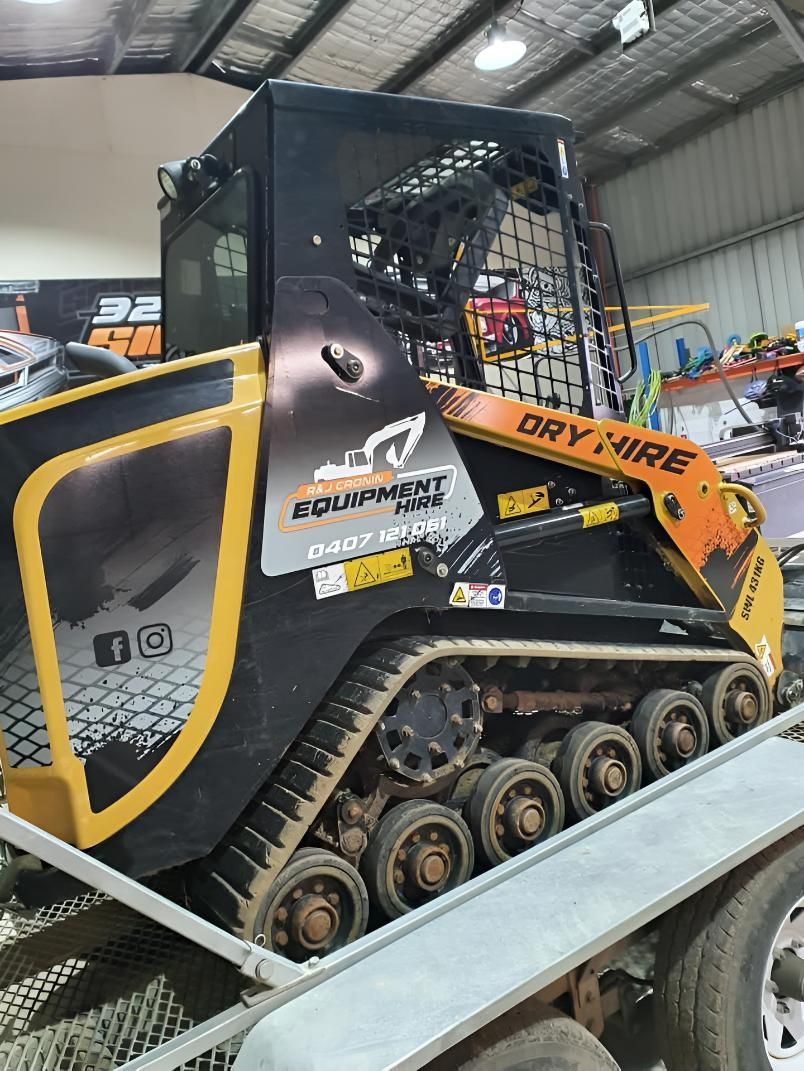 A Bulldozer Is Sitting on Top of A Trailer — R&J Cronin Equipment Hire in Wyee, NSW