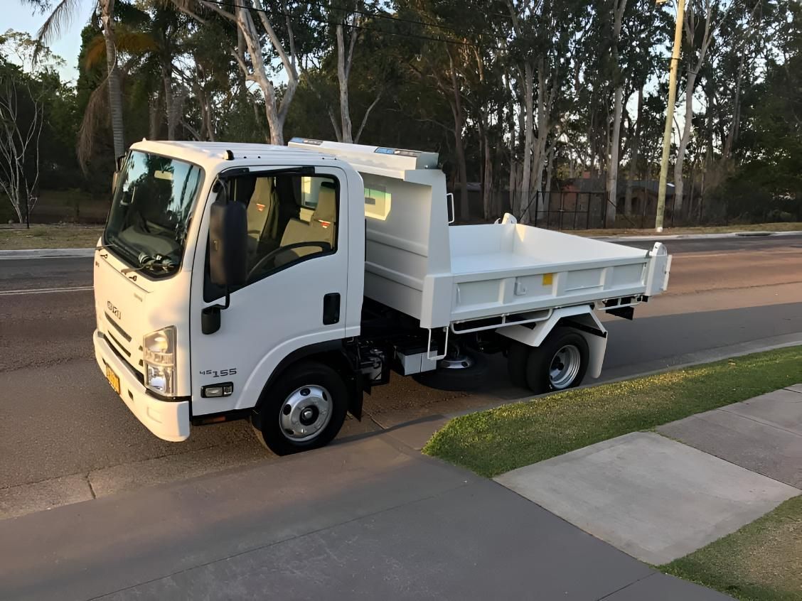 A White Dump Truck Is Parked — R&J Cronin Equipment Hire in Cooranbong, NSW