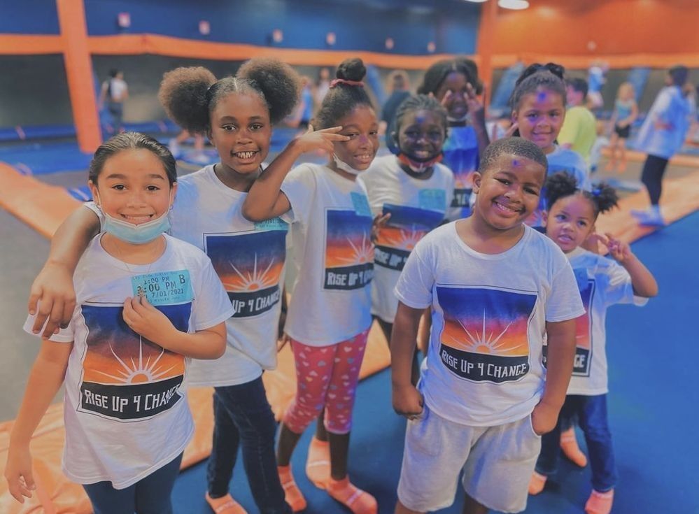 A group of seven children in matching white 