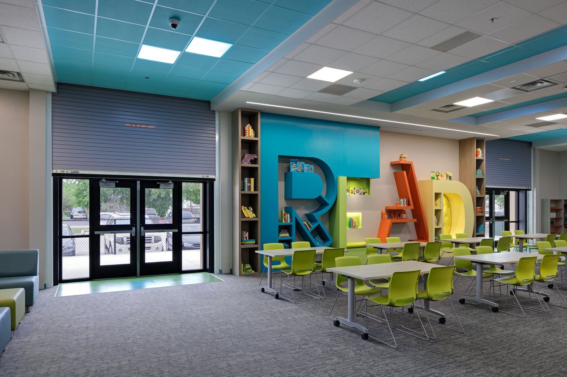 A room with tables and chairs and the word read on the wall