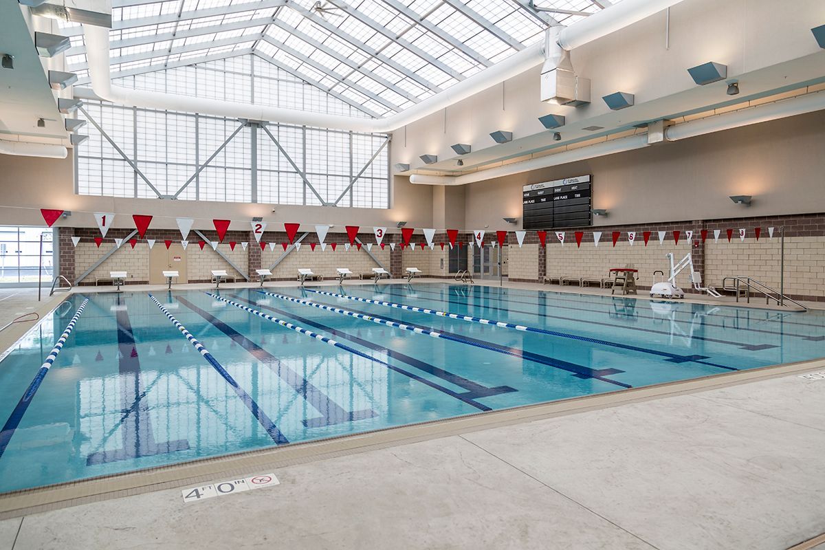 There is a large indoor swimming pool with a roof.