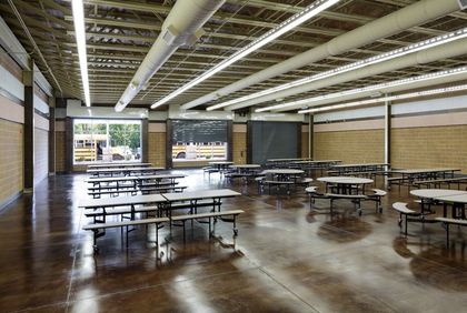 A large room with tables and benches in it