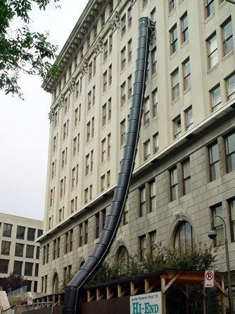 A large building with a black pipe coming out of it