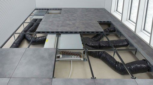 A room with a tiled floor and a bunch of pipes coming out of it.