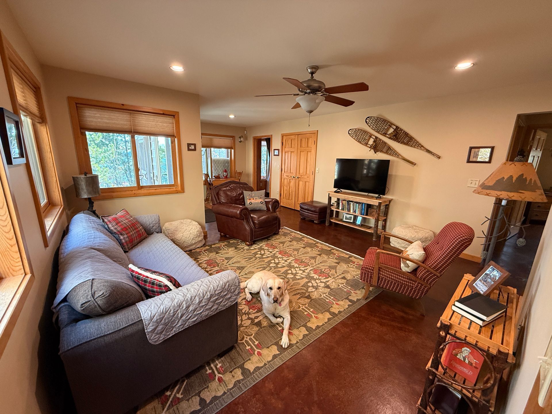 A living room with a couch , chairs , and a coffee table.
