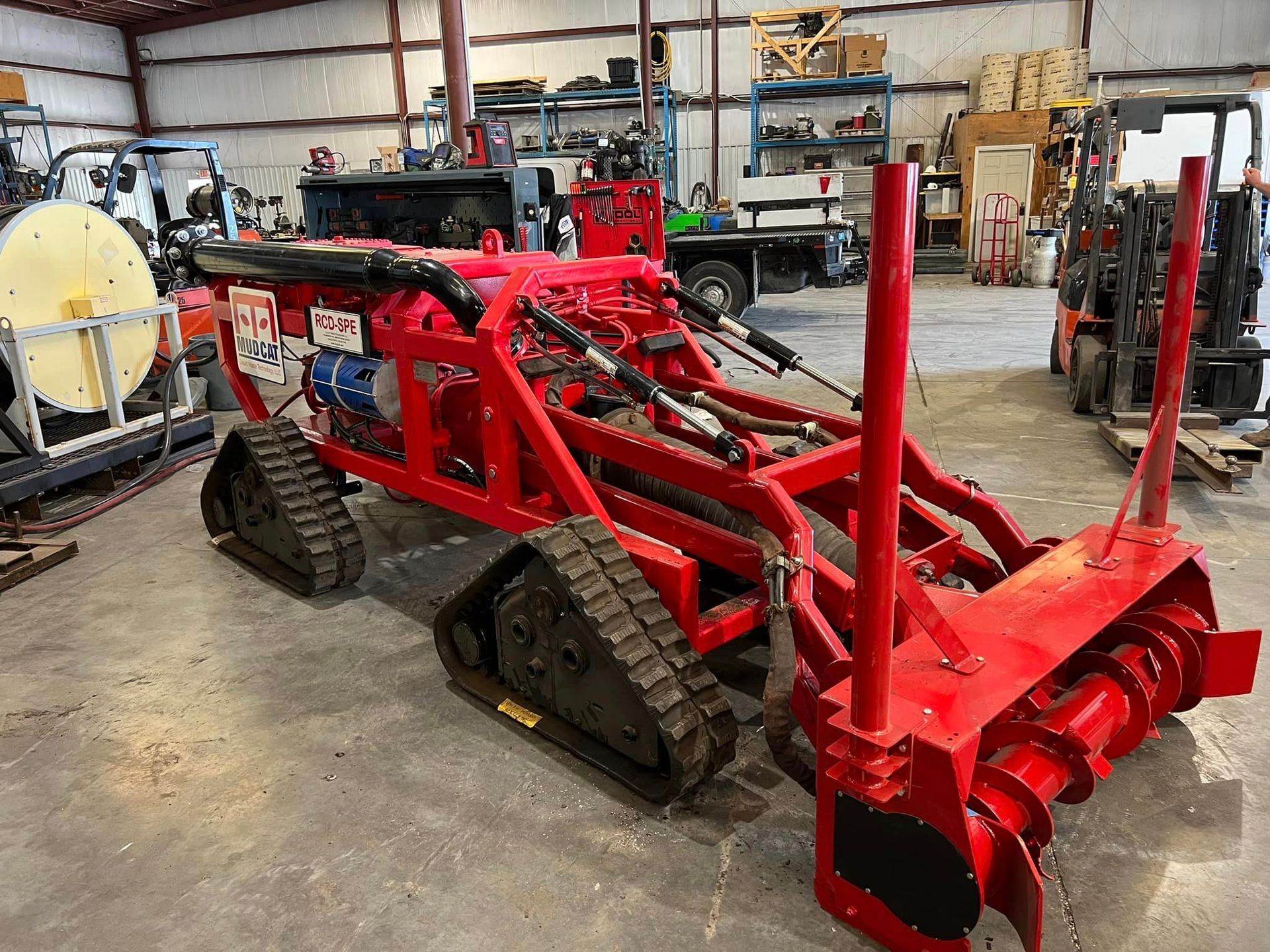 Revolutionize sediment removal with the MudCat ROV Dredge—efficient, precise, and eco-friendly dredging solutions. Click to learn more! A red tractor is sitting on top of a dirt field.