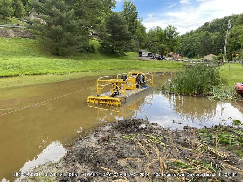 Compact excavator trenching for underground utilities on a residential site.