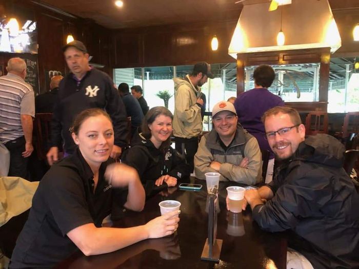 a group of people are sitting at a table in a restaurant