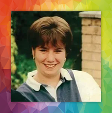 a woman is smiling in front of a rainbow background .