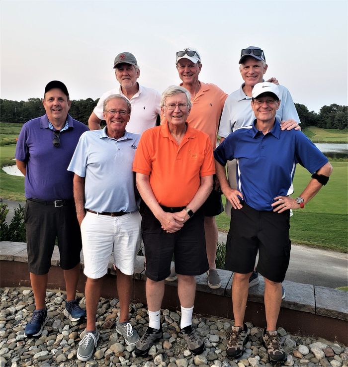 a group of men are posing for a picture together