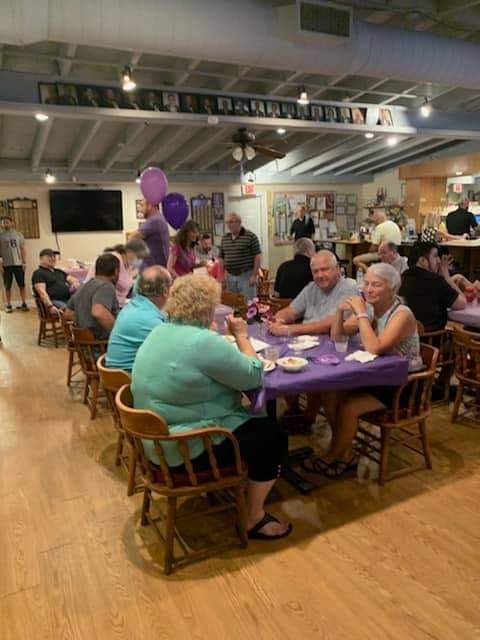 a group of people are sitting at tables in a room .