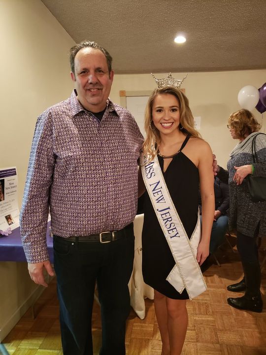 a woman wearing a sash that says miss new jersey