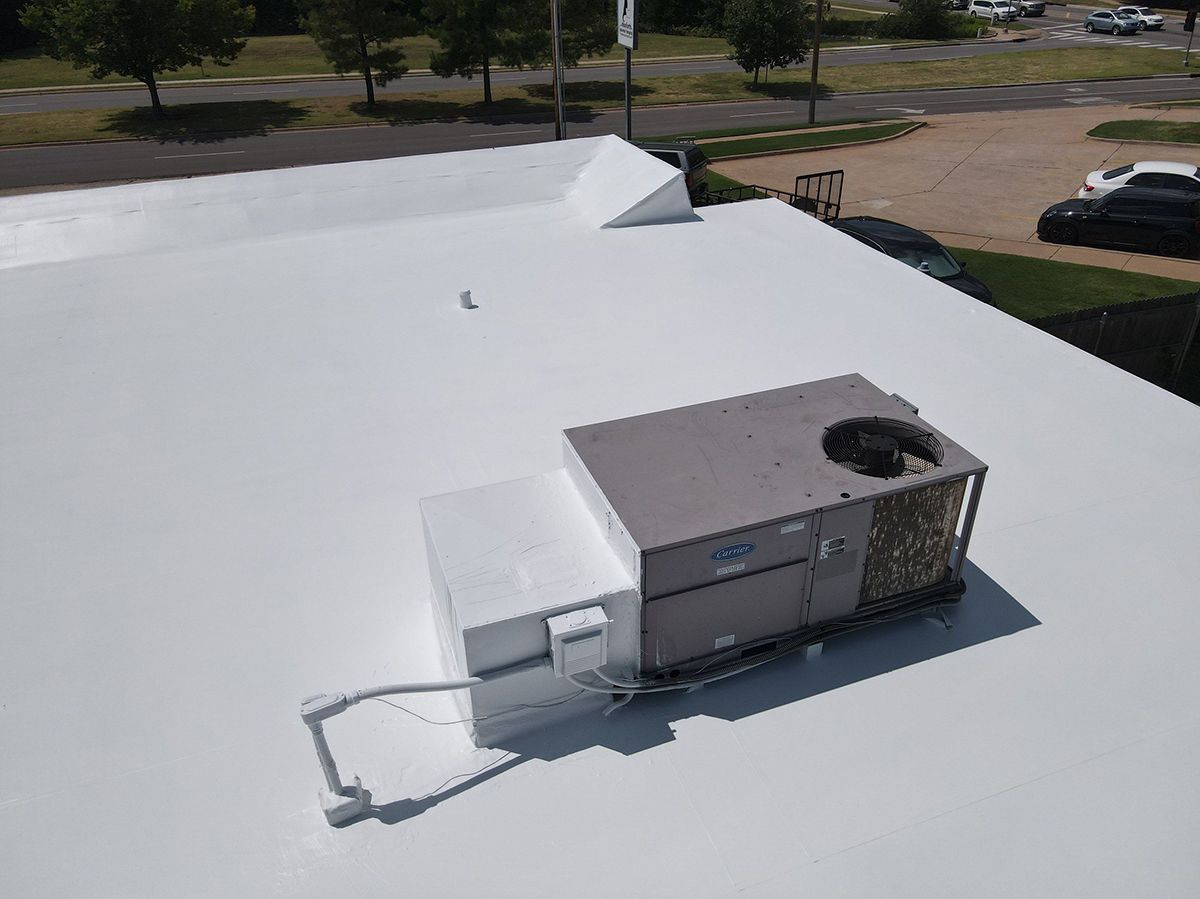 White commercial roof with HVAC unit.