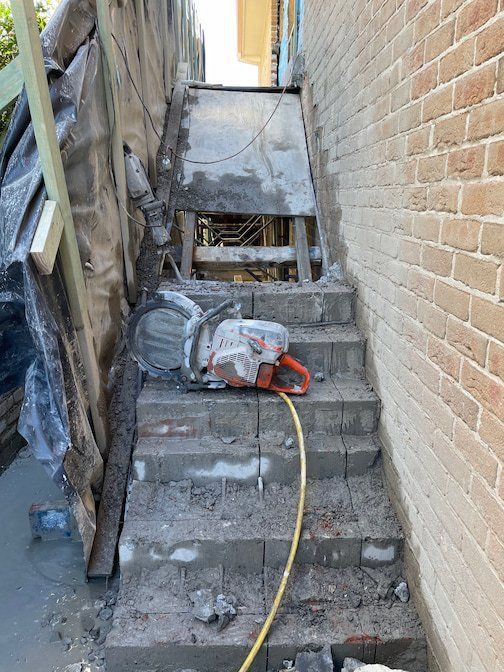 Concrete Steps With a Circular Saw, Next to a Brick Wall — Coastcut Concrete Cutting Pty Ltd in Corlette, NSW
