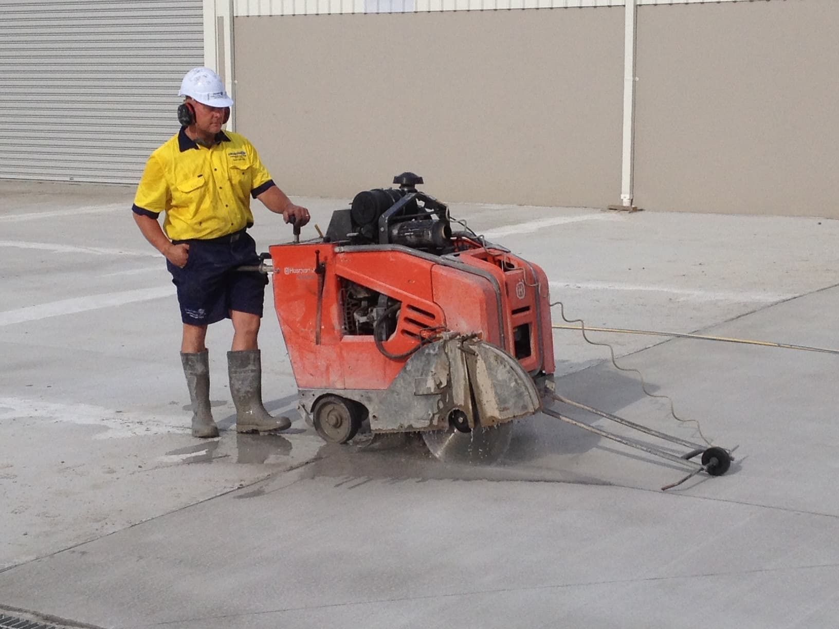 Man Operating a Concrete Saw to Cut Lines in a Concrete Surface — Coastcut Concrete Cutting Pty Ltd in Maitland, NSW