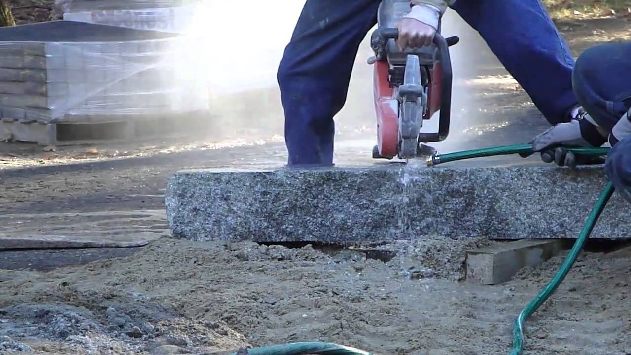 Person Using a Jackhammer to Cut a Large Stone Slab — Coastcut Concrete Cutting Pty Ltd in Newcastle, NSW