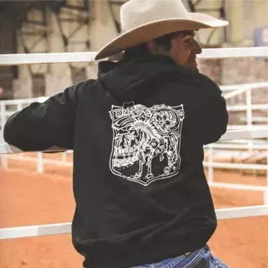 A man wearing a cowboy hat and a black hoodie