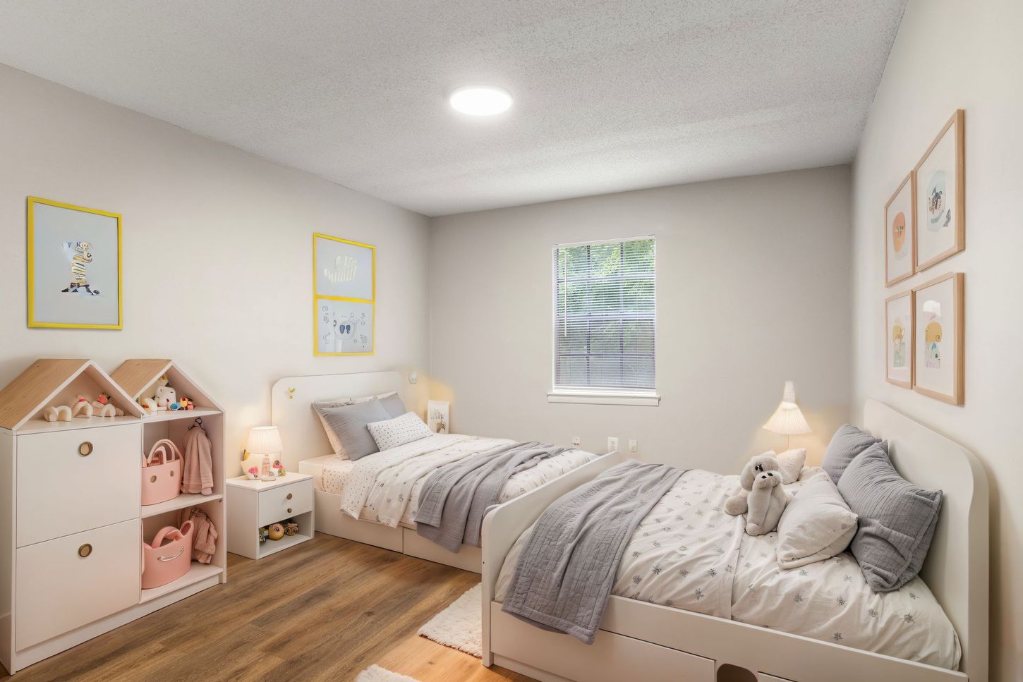 A bedroom with two beds and a window.