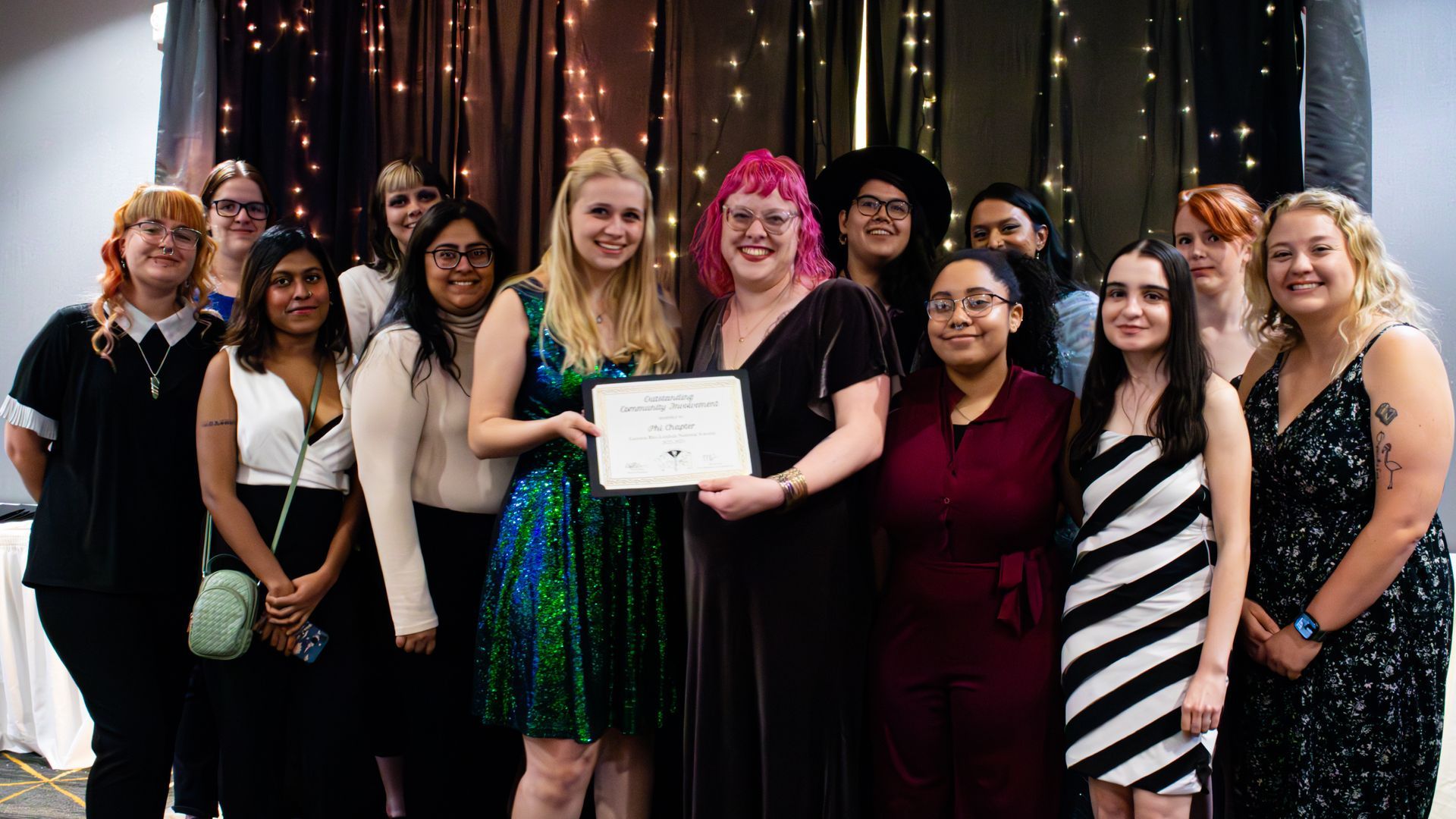 Members of Phi Chapter posting with an award at Convention 2023