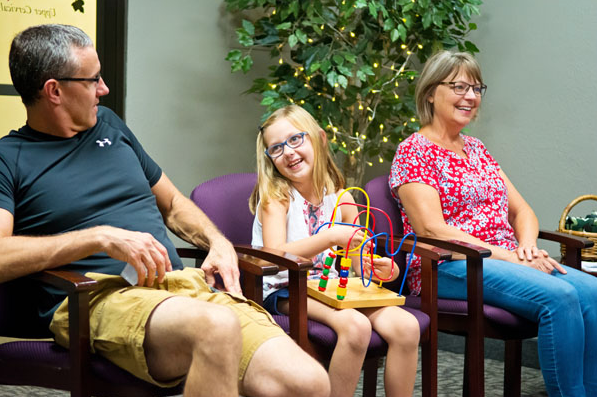 girl with her parents in waiting room