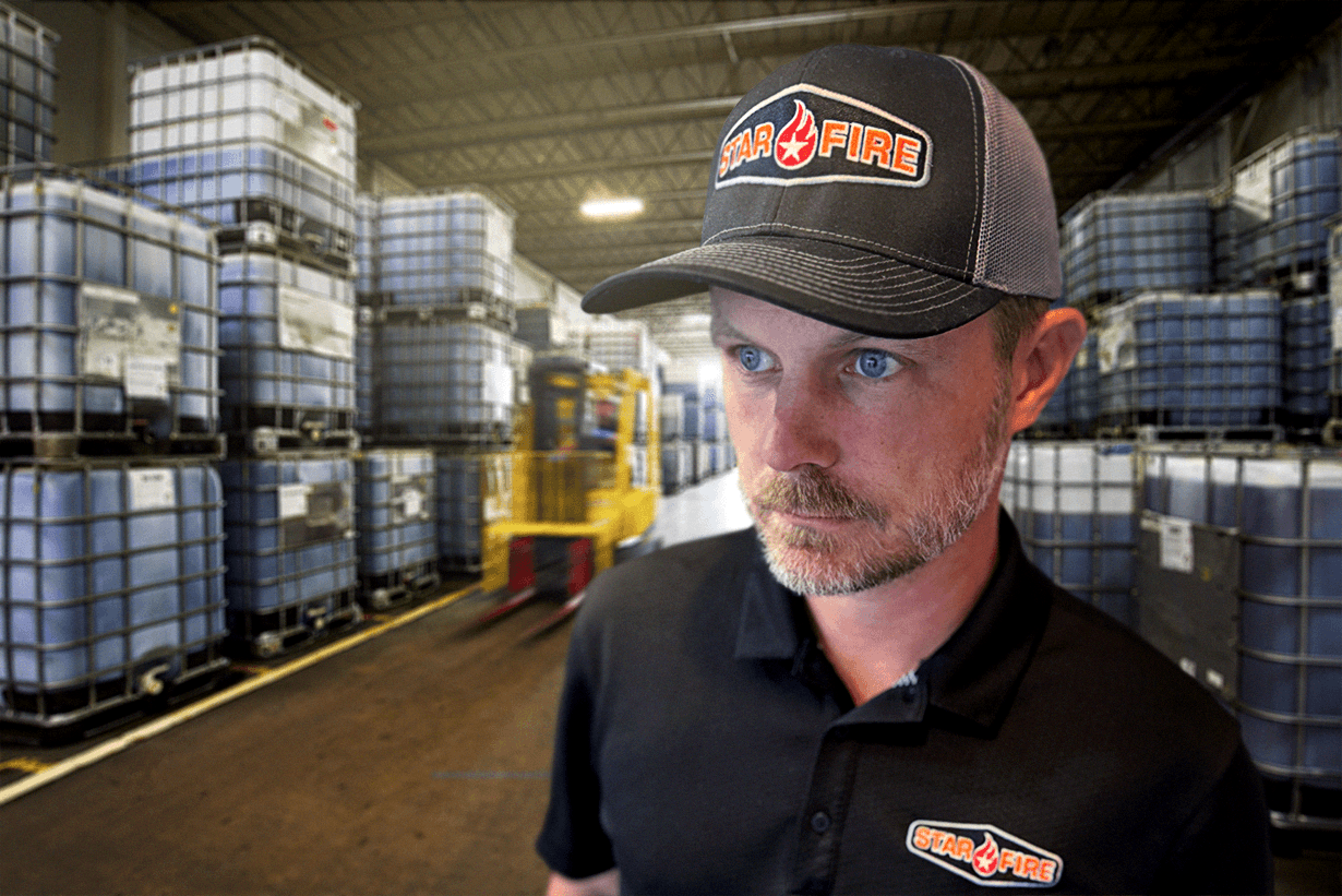 Man in a warehouse wearing a STARFIRE hat and golf shirt
