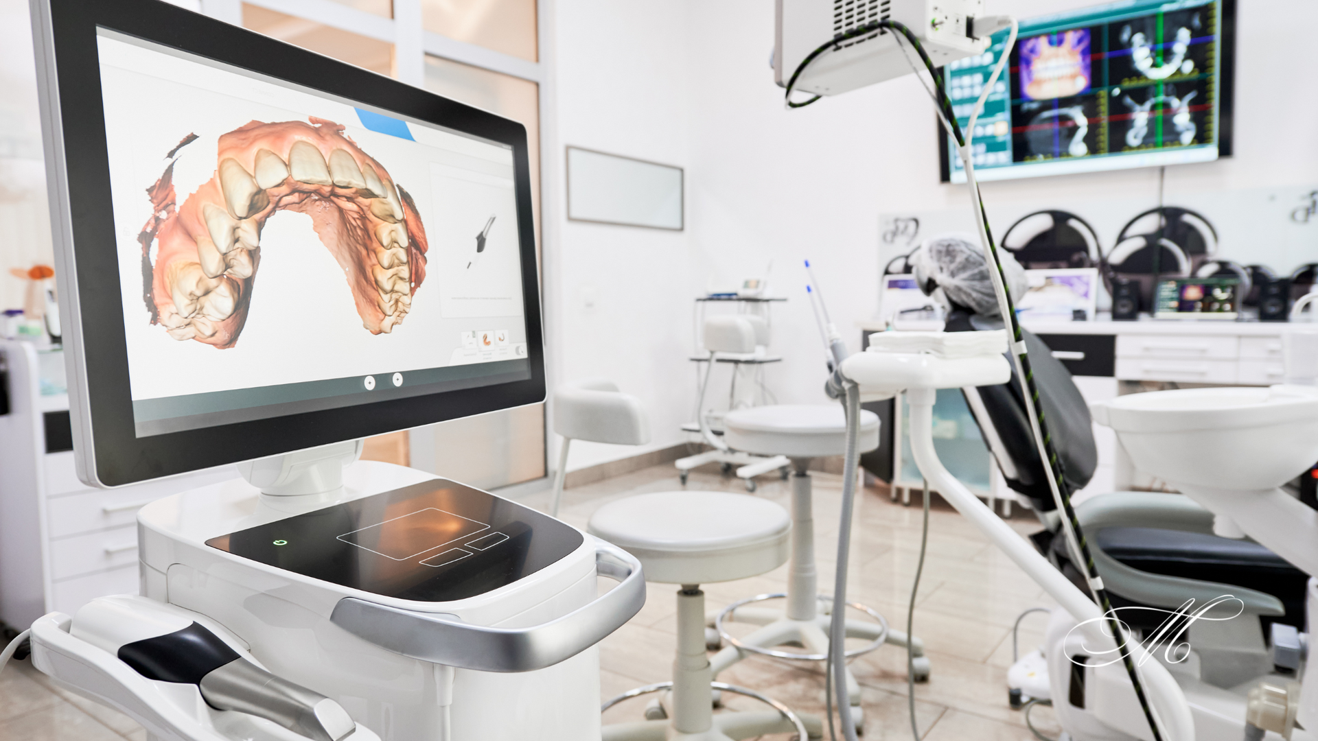 A dental office with a computer and a dental chair.