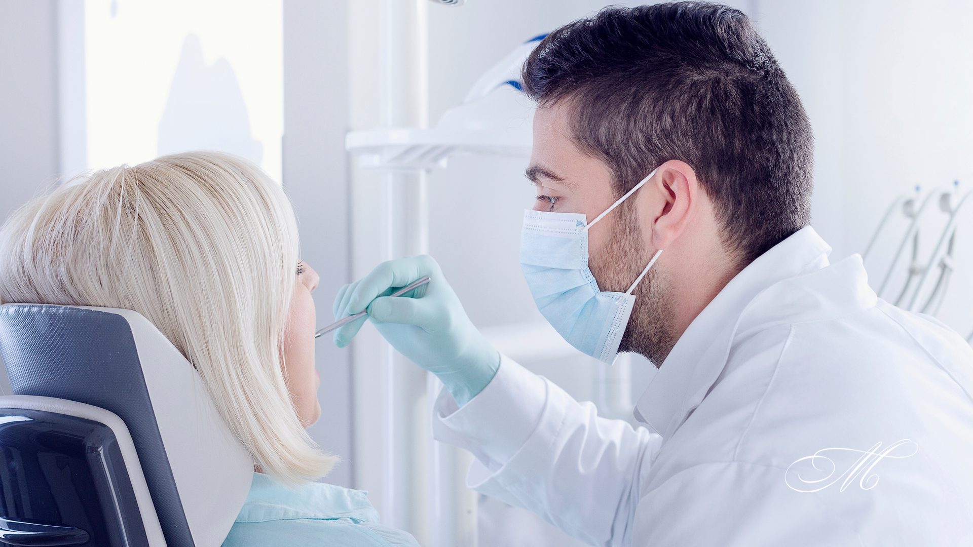 A dentist is examining a woman 's teeth in a dental office.