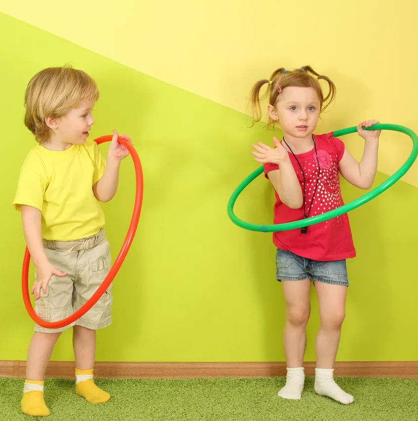 Lala's Lullaby's group Family Day Care - two children playing with hula hoops