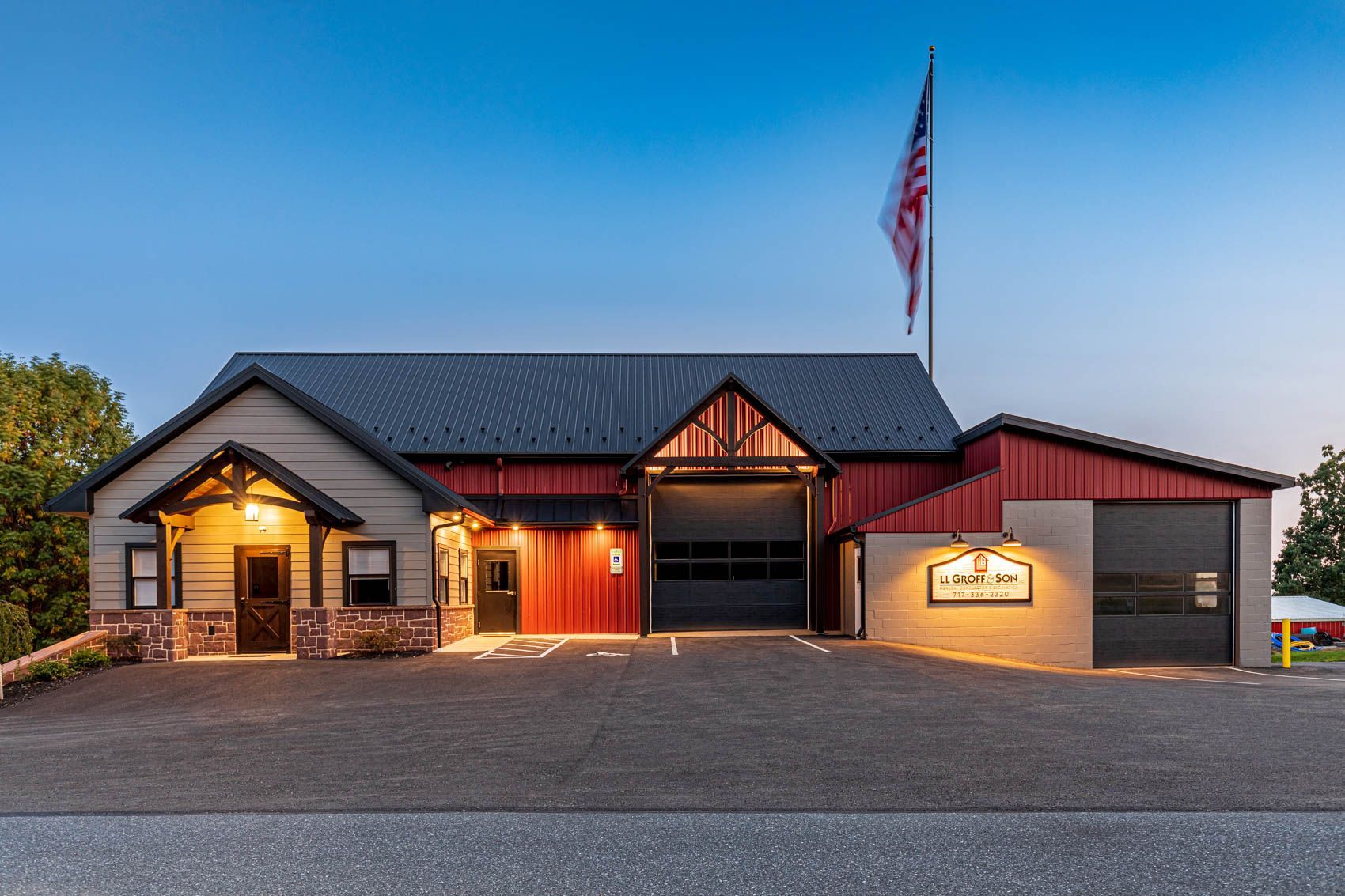 Building with open garage doors and an American flag.