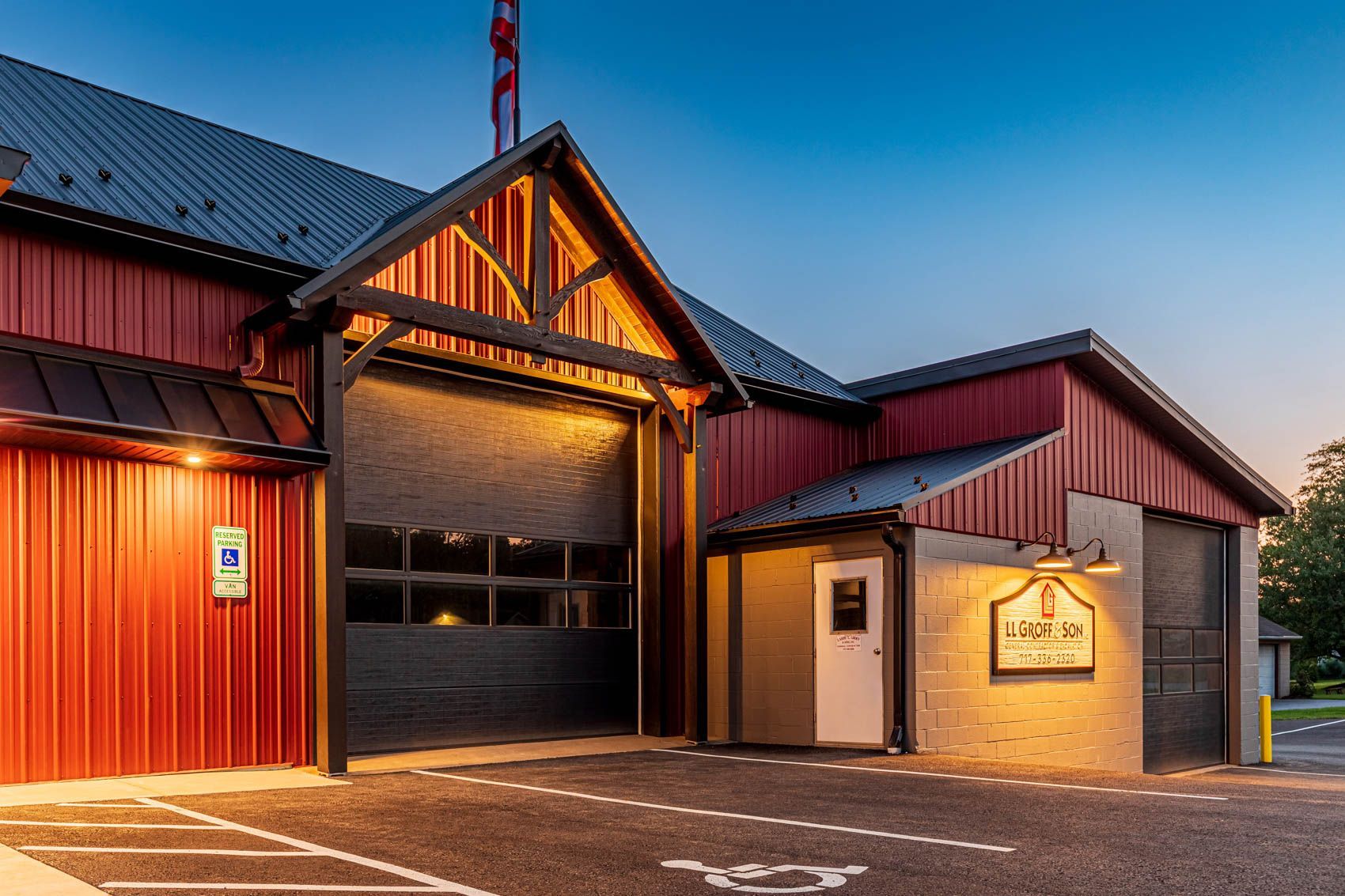 Red and black building with garage doors; a sign reads 